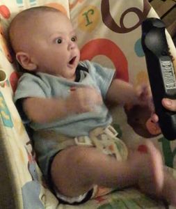 Baby_goes_crazy_over_a_remote_control.jpg